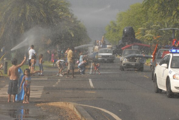 JOINT BASE PEARL HARBOR HICKAM, Hawaii -- Hickam Spectators took part in the Beach Bum Parade Parade began at Bishop's Point Pier and ended at Hickam Harbor with free food and entertainment at Foster Point Pavilion. Those who wanted to were able to campout at Hickam Harbor after the parade for a fun, family night, gathered around a campfire for free s'mores. Once the sun set, campers enjoyed a movie on the beach on a large outdoor movie screen. (U.S. Air Force photo/Staff Sgt. Mike Meares) 