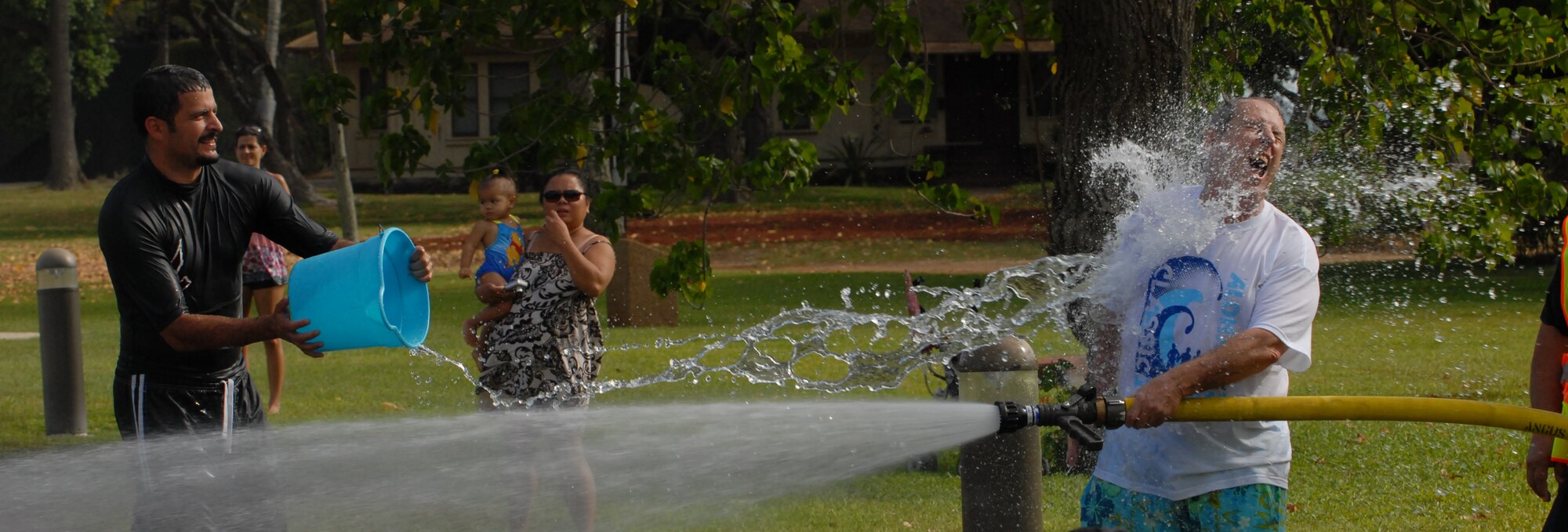 JOINT BASE PEARL HARBOR HICKAM, Hawaii -- Hickam Spectators took part in the Beach Bum Parade Parade began at Bishop's Point Pier and ended at Hickam Harbor with free food and entertainment at Foster Point Pavilion. Those who wanted to were able to campout at Hickam Harbor after the parade for a fun, family night, gathered around a campfire for free s'mores. Once the sun set, campers enjoyed a movie on the beach on a large outdoor movie screen. (U.S. Air Force photo/Staff Sgt. Mike Meares) 