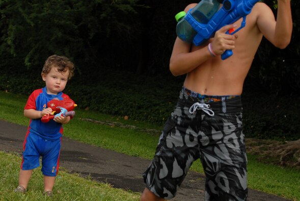 JOINT BASE PEARL HARBOR HICKAM, Hawaii -- Jase Deans, 2, gets his water gun ready to fire upon the floats that are rolling down the parade path toward him during Hickam's annual Beach Bum Parade May 21. The parade began at Bishop?s Point Pier and ended at Hickam Harbor with free food and entertainment at Foster Point Pavilion. Those who wanted to were able to campout at Hickam Harbor after the parade for a fun, family night, gathered around a campfire for free s'mores. Once the sun set, campers enjoyed a movie on the beach on a large outdoor movie screen. (U.S. Air Force photo/Staff Sgt. Mike Meares)