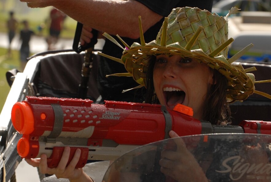JOINT BASE PEARL HARBOR HICKAM, Hawaii -- Sydney Barrett, daughter of Col. Sam Barrett, 15th Wing commander, prepares to fire her water cannon during the annual Beach Bum Parade May 21 on Hickam. Colonel Barrett and his family took on spectators with water balloons, fire hoses, water guns, water cannons and water hoses as they rolled by in the parade. Parade began at Bishop's Point Pier and ended at Hickam Harbor with free food and entertainment at Foster Point Pavilion. Those who wanted to were able to campout at Hickam Harbor after the parade for a fun, family night, gathered around a campfire for free s'mores. Once the sun set, campers enjoyed a movie on the beach on a large outdoor movie screen. (U.S. Air Force photo/Staff Sgt. Mike Meares)