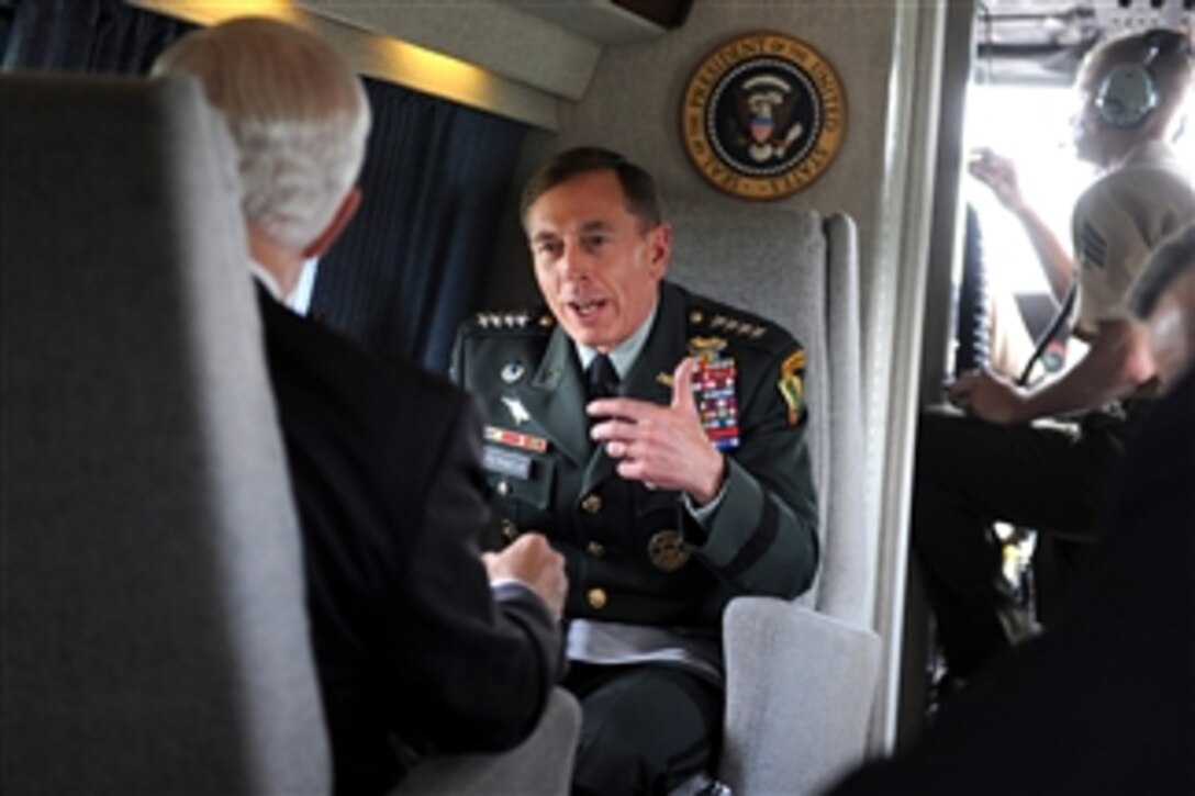 Commander of U.S. Central Command Gen. David Petraeus, U.S. Army, speaks with Secretary of Defense Robert M. Gates aboard a U.S. Marine Corps helicopter from Marine Helicopter Squadron 1 after the activation ceremony of U.S. Cyber Command at Fort Meade, Md., on May 21, 2010.  