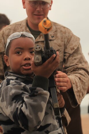 NEW YORK -- Marines from Weapons Company, 3rd Battalion, 9th Marine Regiment, Special Purpose Marine Air Ground Task Force - New York, demonstrated a helicopter raid on the Coney Island Beach, May 27, 2010.  Marines allowed visitors to try on their equipment, hold their weapons and tour the helicopters used for the demonstration. More than 3,000 Marines, Sailors and Coast Guardsmen will be in the area participating in community outreach events and equipment demonstrations. This is the 26th year New York City has hosted the sea services for Fleet Week. (Official Marine Corps photo by Sgt. Randall A. Clinton / RELEASED)