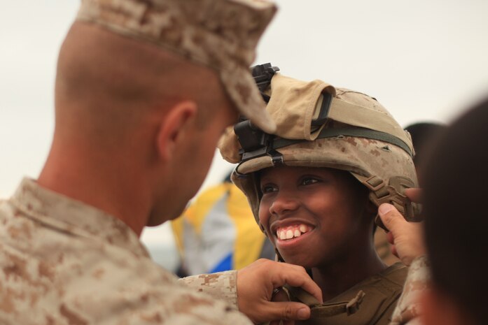 NEW YORK -- Marines from Weapons Company, 3rd Battalion, 9th Marine Regiment, Special Purpose Marine Air Ground Task Force - New York, demonstrated a helicopter raid on the Coney Island Beach, May 27, 2010.  Marines allowed visitors to try on their equipment, hold their weapons and tour the helicopters used for the demonstration. More than 3,000 Marines, Sailors and Coast Guardsmen will be in the area participating in community outreach events and equipment demonstrations. This is the 26th year New York City has hosted the sea services for Fleet Week. (Official Marine Corps photo by Sgt. Randall A. Clinton / RELEASED)