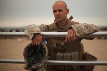 NEW YORK -- Lance Cpl. Miroslav Kazimir, Weapons Company, 3rd Battalion, 9th Marine Regiment, Special Purpose Marine Air Ground Task Force - New York, rests on a railing after demonstrated a helicopter raid on the Coney Island Beach, May 27, 2010.  The Marines allowed visitors to try on their equipment, hold their weapons and tour the helicopters used for the demonstration. The Slovakian-native machine gunner is one of More than 3,000 Marines, Sailors and Coast Guardsmen in the area participating in community outreach events and equipment demonstrations. This is the 26th year New York City has hosted the sea services for Fleet Week. (Official Marine Corps photo by Sgt. Randall A. Clinton / RELEASED)