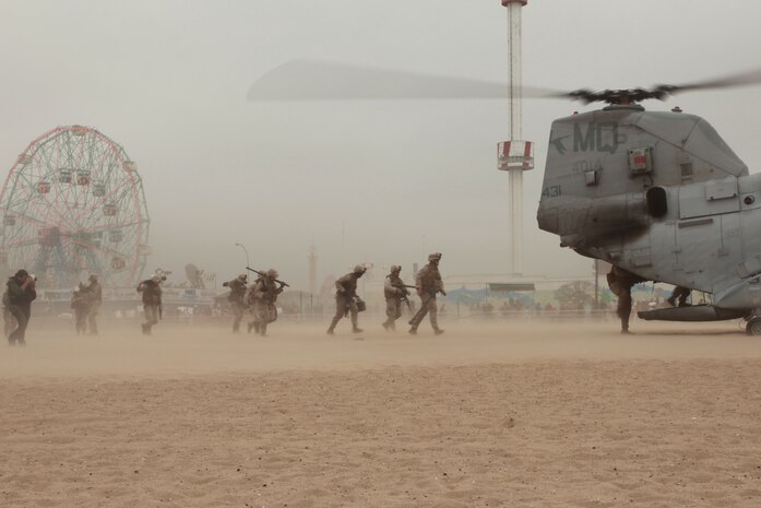 NEW YORK -- Marines from Weapons Company, 3rd Battalion, 9th Marine Regiment, Special Purpose Marine Air Ground Task Force - New York, demonstrated a helicopter raid on the Coney Island Beach, May 27, 2010.  Marines allowed visitors to try on their equipment, hold their weapons and tour the helicopters used for the demonstration. More than 3,000 Marines, Sailors and Coast Guardsmen will be in the area participating in community outreach events and equipment demonstrations. This is the 26th year New York City has hosted the sea services for Fleet Week. (Official Marine Corps photo by Sgt. Randall A. Clinton / RELEASED)