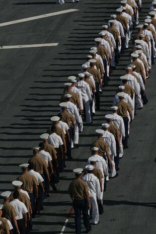 U.S. Sailors and Marines man the rails of the USS Iwo Jima as it pulls into New York for Fleet Week, May 26, 2010. More than 3,000 Marines, Sailors and Coast Guardsmen will be in the area participating in community outreach events and equipment demonstrations. This is the 26th year New York City has hosted the sea services for Fleet Week. (U.S. Marine Corps photo by Cpl. Patrick P. Evenson)
