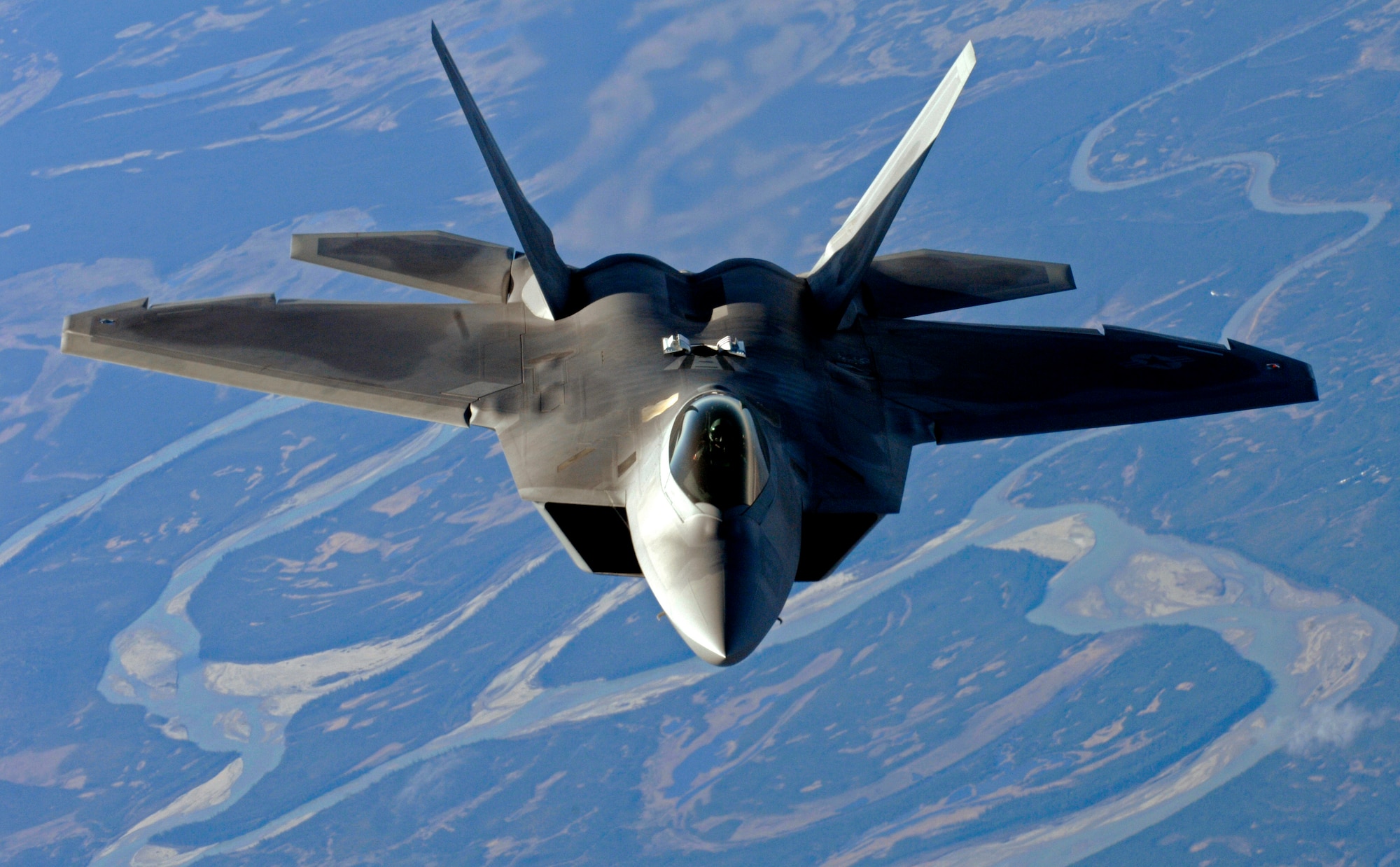 An F-22 Raptor from Elmendorf Air Force Base descends after refueling over Alaska May 26. (U.S. Air force photo/Staff Sgt. Brian Ferguson)