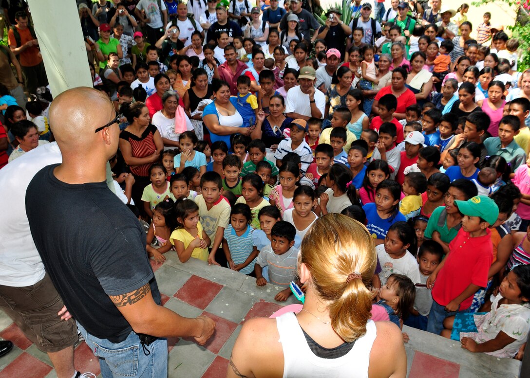 Airmen from Joint Task Force-Bravo’ s Medical Element talk to the people from the community of El Ceda, Comayagua about dental care during the Chapel Hike May 22. Team JTF-B hiked nearly four miles to delivering more than a ton of food and supplies to the community. (U.S. Air Force Photo/Staff Sgt. Bryan Franks)