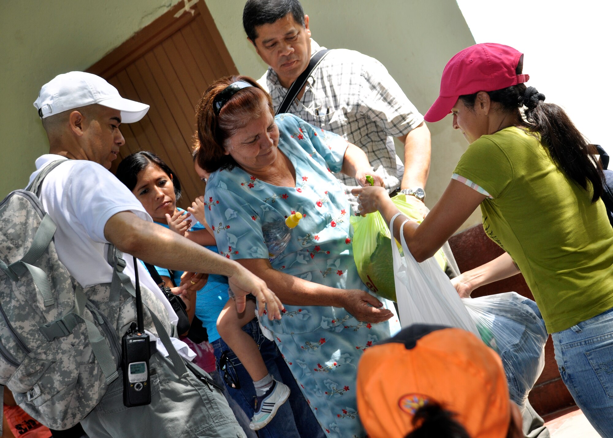 Soldiers, Sailors, Airmen, Marine and civilians passed out food and clothes during the Chapel to families in the community of El Ceda, Comayagua May 22. More than 60 members of Team Joint Task Force-Bravo hiked nearly four miles to deliver food and supplies to the community. (U.S. Air Force Photo/Staff Sgt. Bryan Franks)