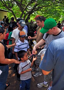 Team Joint Task Force-Bravo passed out candy to the children of El Ceda, Comayagua during the Chapel Hike May 22. More than 60 members of Team JTF-B hiked nearly four miles to deliver more than a ton of food and supplies to the community. (U.S. Air Force Photo/Staff Sgt. Bryan Franks)