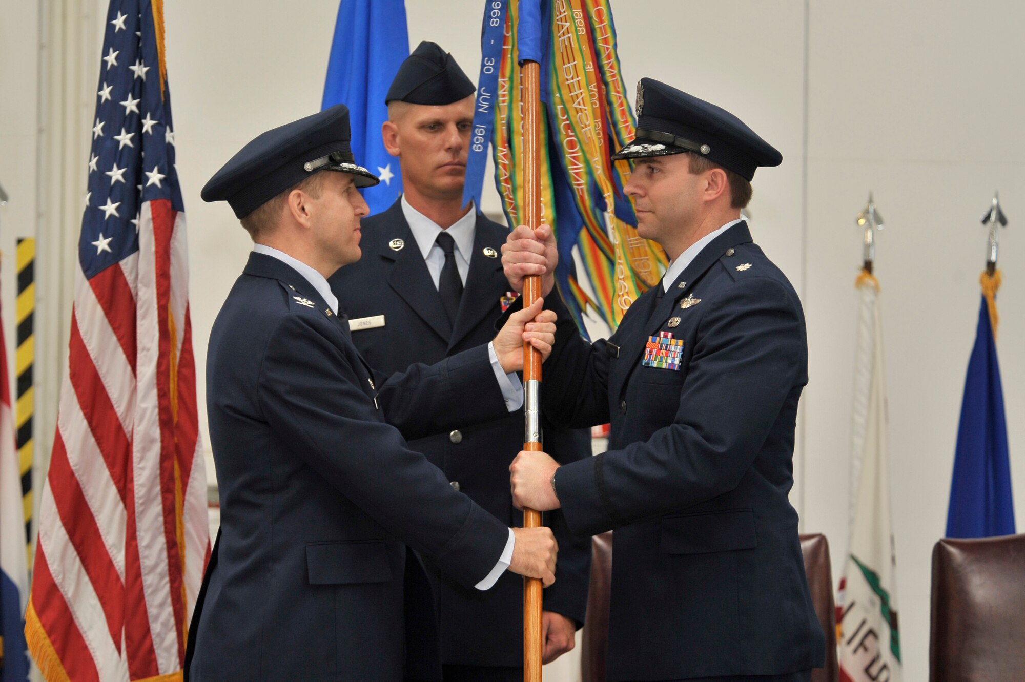 Col. James Slife (left), 27th Special Operations Group commander, presents Lt. Col. Stewart Hammons, 3rd Special Operations Squadron incoming commander, with the squadron guidon, May 27.  Lt. Col. Robert Brock relinquished command of the squadron after heading it since October 2008. (U.S. Air Force photo by Staff Sgt. Heather R. Redman)