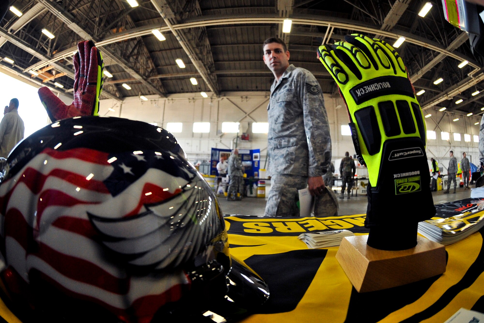 ELMENDORF AIR FORCE BASE, Alaska – An Airman walks by a safety table display, May 27. Elmendorf kicked off the Critical Days of Summer campaign by hosting the annual safety fair inside Hangar 5. Around 20 safety-related vendors were on-hand with displays. (Air Force photo by Airman 1st Class Christopher Gross)