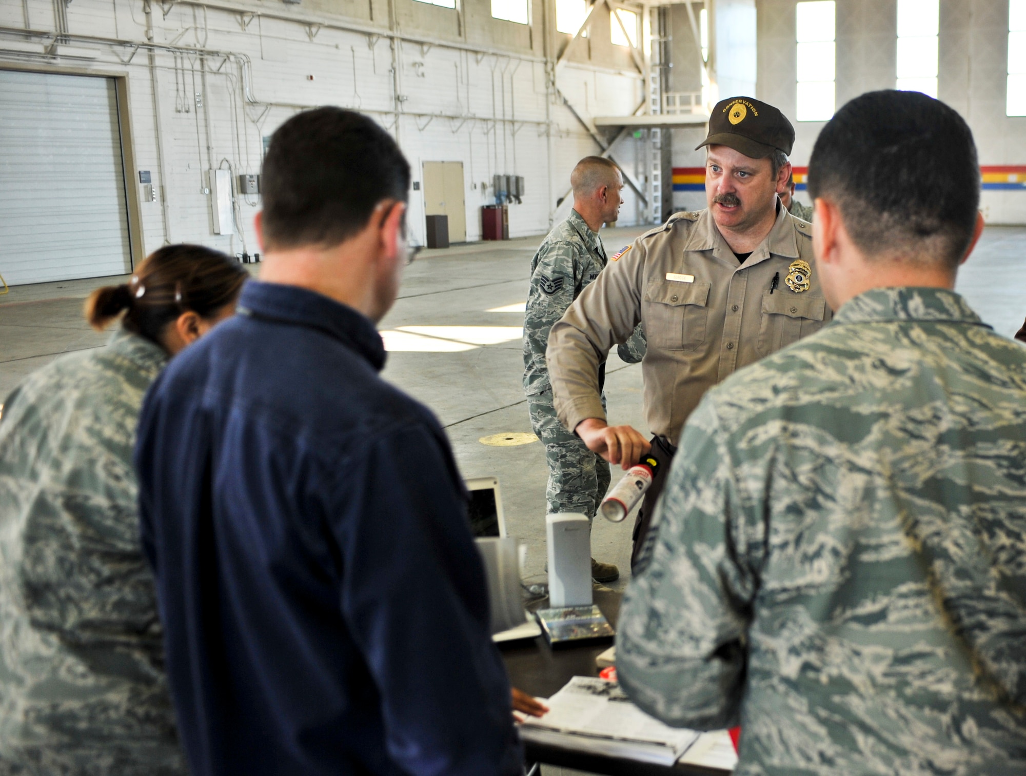 ELMENDORF AIR FORCE BASE, Alaska – Mark Sledge, Conservation Enforcement Office, goes over the proper use and importance of bear spray, May 27. Elmendorf kicked off the Critical Days of Summer campaign by hosting the annual safety fair inside Hangar 5. Around 20 safety-related vendors were on-hand with displays. (Air Force photo by Airman 1st Class Christopher Gross)