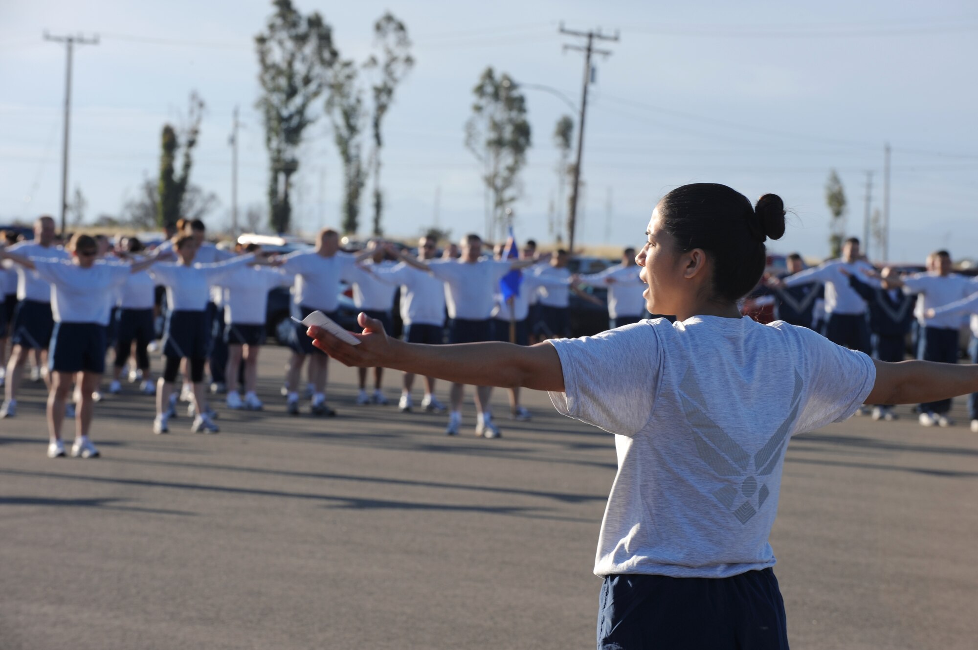 VANDENBERG AIR FORCE BASE, Calif. -- While doing arm circles, members of Team V warm up before taking part in the 30th Space Wing 5K Fit-to-Fight Run here Thursday, May 27, 2010. Airmen from the 30th SW and the base's tenant units run together every month. (U.S. Air Force photo/ Senior Airman Ashley Reed)