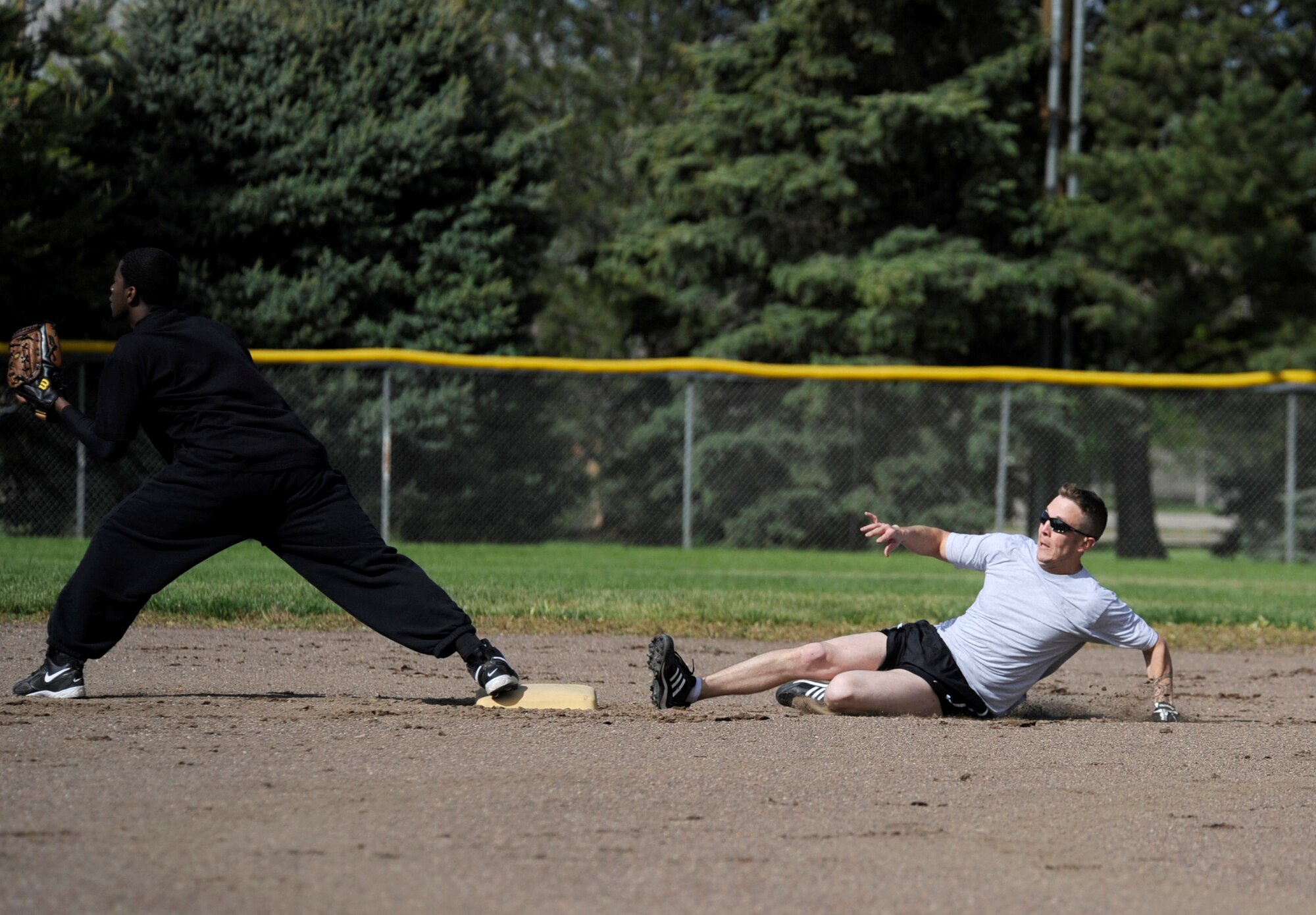 MOUNTAIN HOME AIR FORCE BASE, Idaho -- Jacob Casey, Security Forces Squadron left center field, slides into second during an intramural softball game against the Operations Support Squadron May 24. SFS opened the season with a win over OSS 9-5. (U.S. Air Force photo by Airman 1st Class Renishia Richardson)