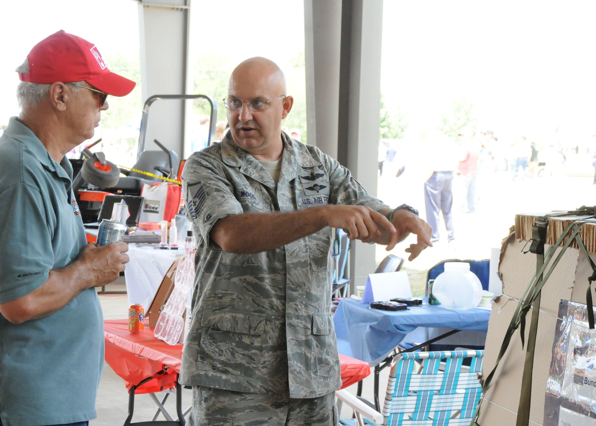 Air Force Reserve Master Sgt. John Wood, 919th Logistics Readiness Squadron, explains to Tyler Hall the process of palletizing airdrop supplies at the Military Appreciation Recognition Celebration May 15 at Old Spanish Trail Park in Crestview.  Several units from Duke Field's 919th Special Operations Wing brought out various displays of military equipment for the public to see.  The MARC is a non-profit organization seeking to honor past and present military members of all branches during the Armed Forces Day weekend. (U.S. Air Force photo/Adam Duckworth)