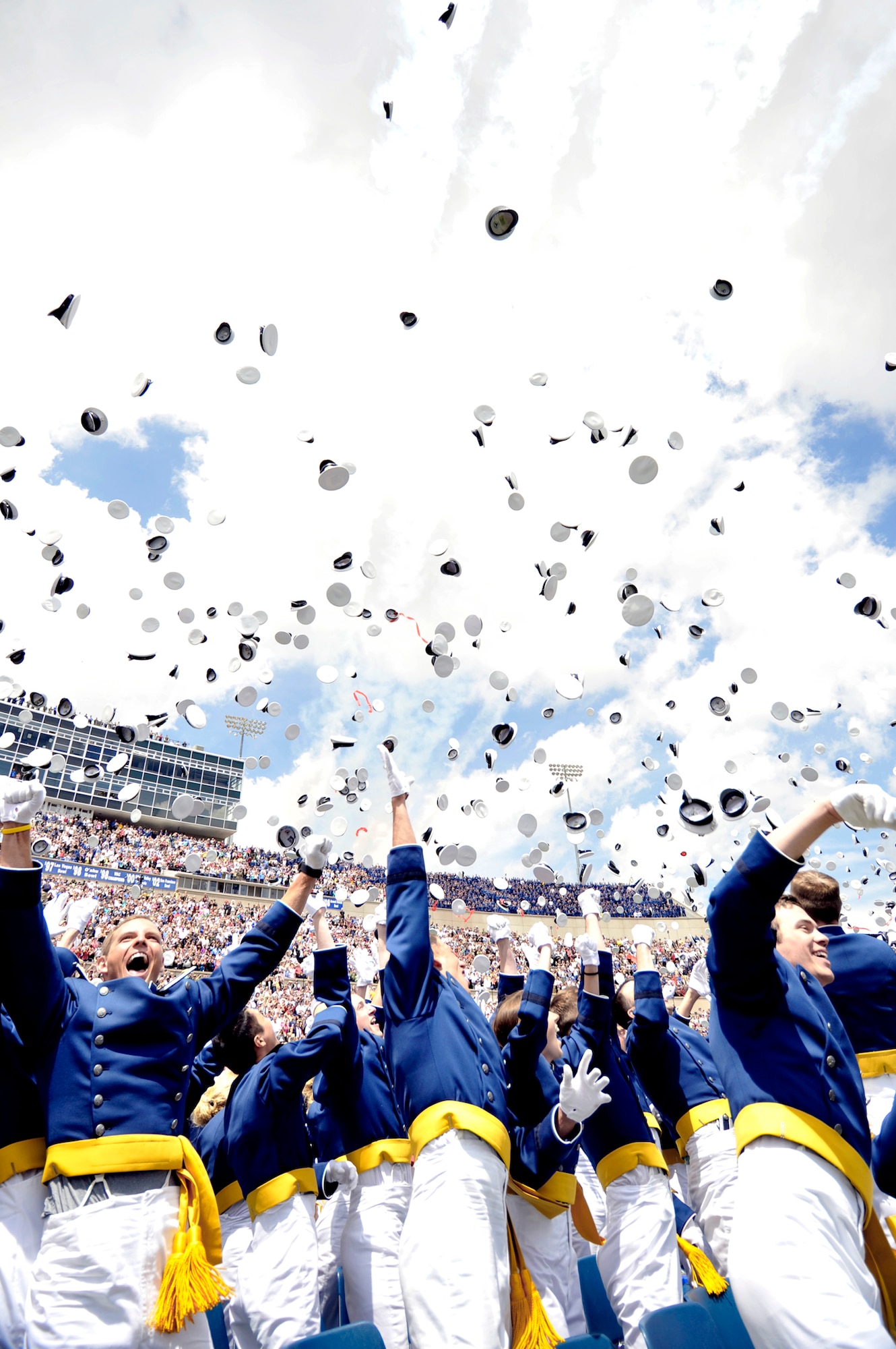 The newly commissioned second lieutenants throw their hats as the Thunderbirds fly over during the class of 2010 graduation ceremonies May 26, 2010, at the U.S. Air Force Academy, Colo. (U.S. Air Force photo/Bill Evans)