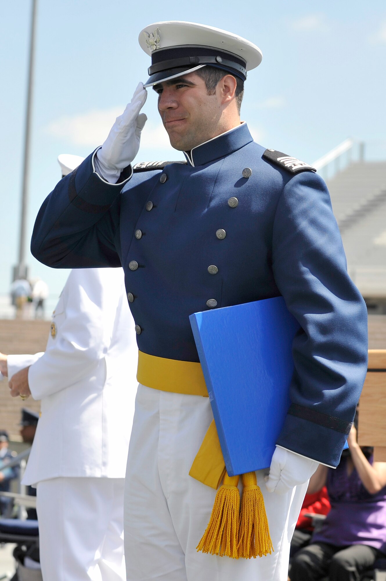 Cadet 1st Class Nicholas Charles salutes after receiving his diploma during the graduation ceremony May 26, 2010, at the U.S. Air Force Academy, Colo. Cadet Charles was one of 1,001 cadets to receive their degrees and commissions as second lieutenants in the Air Force. (U.S. Air Force photo/Mike Kaplan) 