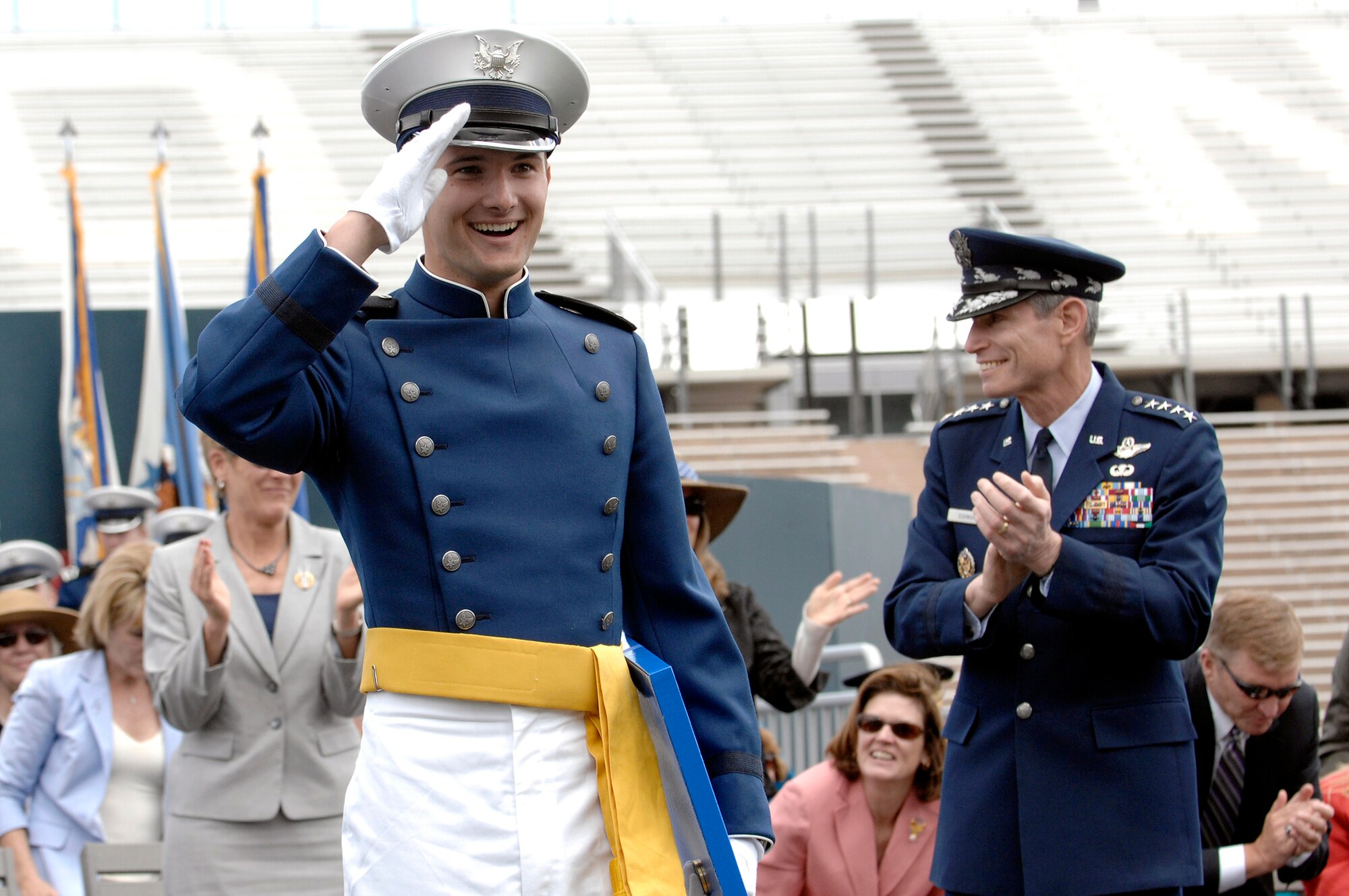 Cadet 1st Class William Weindel salutes his classmates during the U.S. Air Force Academy class of 2010 graduation ceremonies May 26, 2010, at Falcon Stadium in Colorado Springs Colo. Cadet Weindel, the last cadet to cross the stage to receive his diploma, was honored with the traditional name "Tail End Charlie". (U.S. Air Force photo/Mike Kaplan)