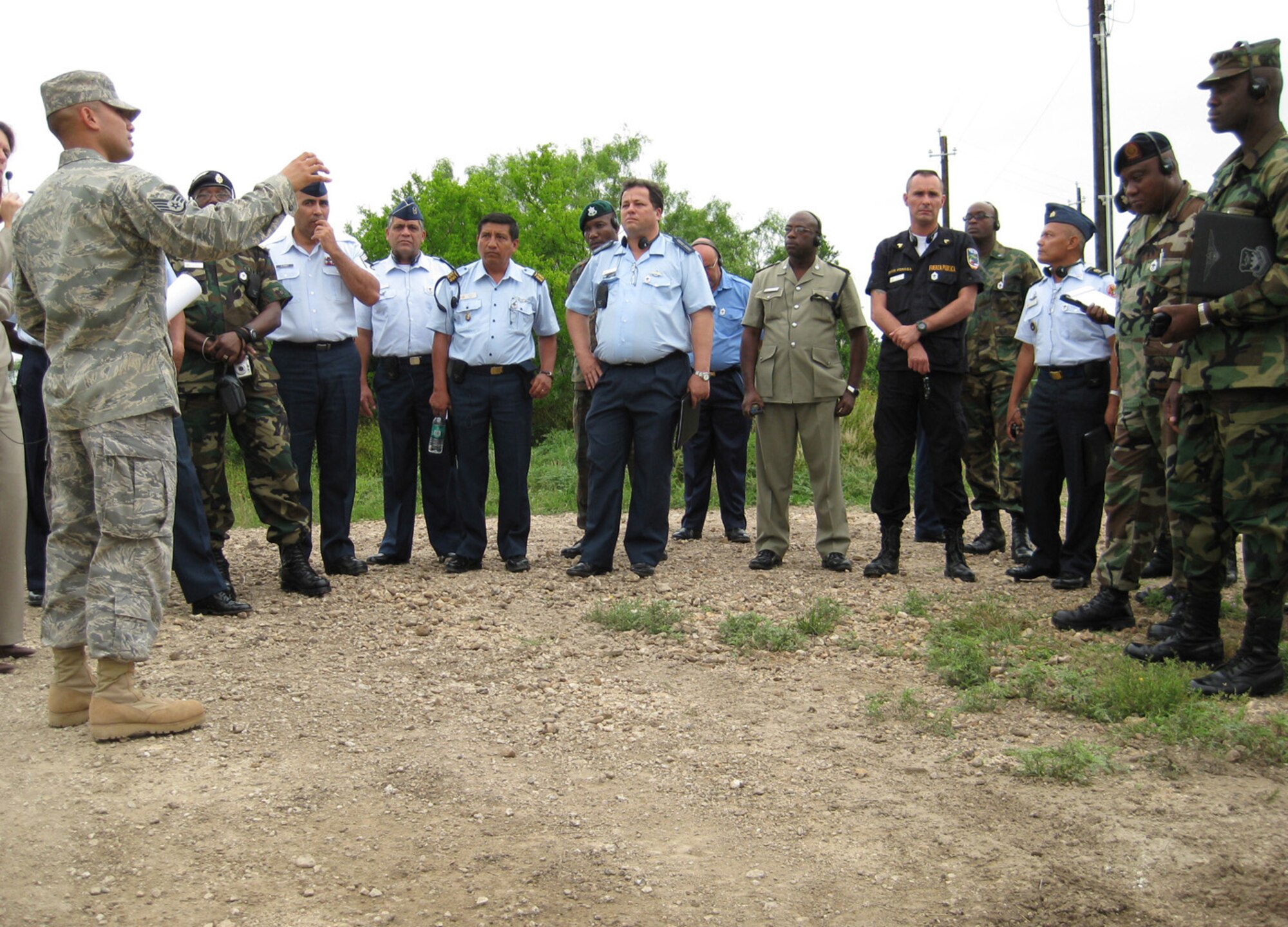 Staff Sgt. Alejandro Huerta, 319th Training Squadron, briefs a group of top senior enlisted military leaders from Latin American and Caribbean nations at the Basic Expeditionary Airman Skills Training site May 20. (U.S. Air Force photo)