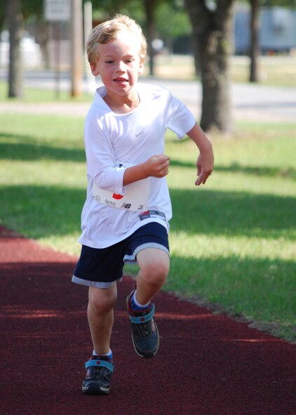 Daniel Dunn heads for the finish line in the annual Duke Field Kids’ Fun Run and Adult 5K held May 15. The event coincided with the Air Force-wide America’s Armed Forces Kids’ Run.  First-place finishers by respective age category included:  Nicholas Ruiz, 5-6 half mile; Faith Alexander, 7-8 half mile;  Austin Bonebrake, 9-13 one mile; Eric Bonebrake, adult 5K.  (U.S. Air Force photo/Tech. Sgt.  Cheryl Foster)