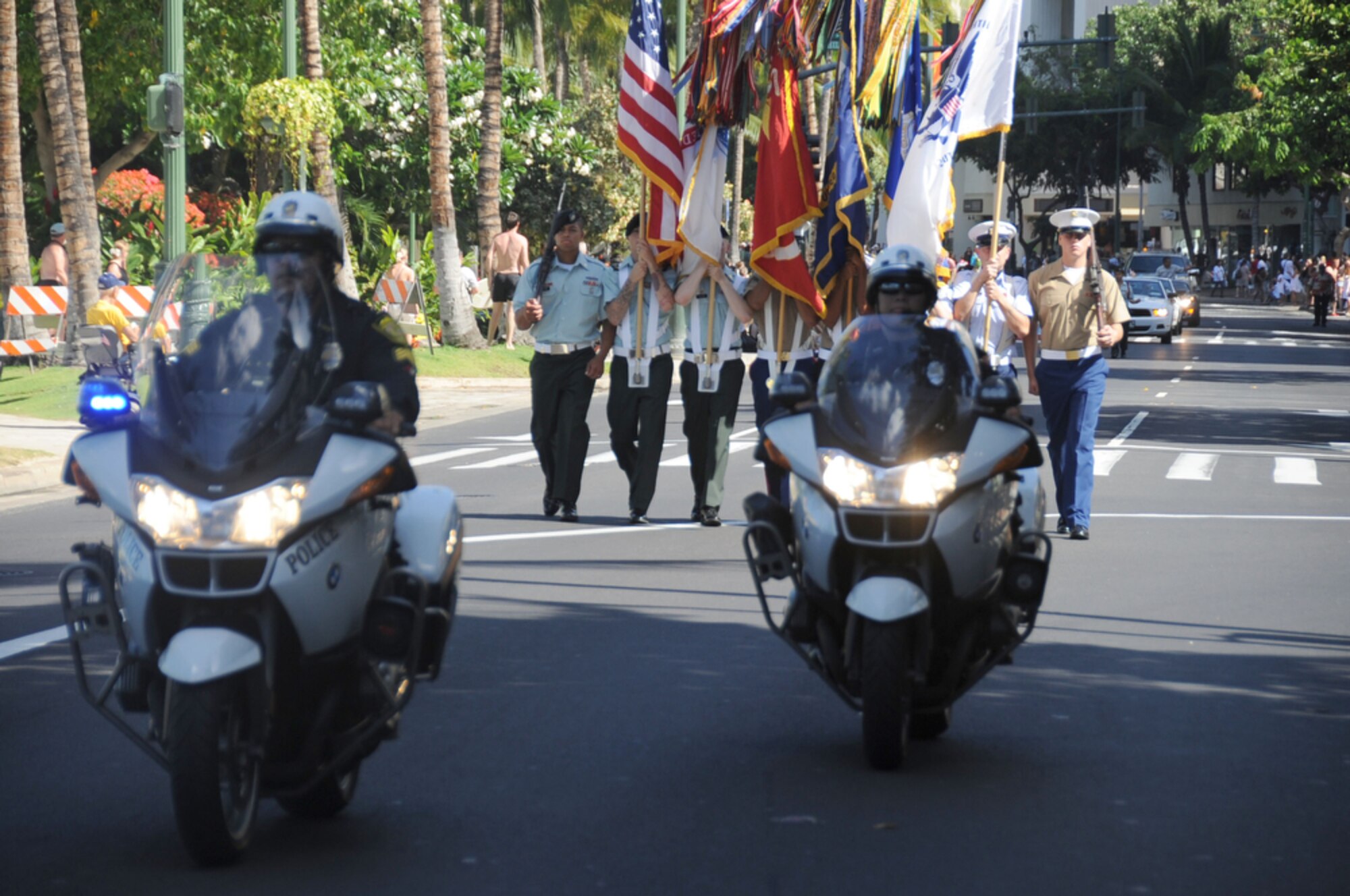 HONOLULU - Honolulu police lead the Joint Color Guard as they make their way down the street to begin the Welcome Home Parade for military members as part of Military Appreciation Day in Honolulu, Hawaii on May 22. The parade was followed up with entertainment at the Waikiki Shell with performances by four local Hawaii bands and a military joint jazz ensemble. The event was organized by the USO, the Chamber of Commerce Military Affairs Council and BAE Systems. (U.S.  Air Force photo/Tech Sgt. Cohen A. Young)