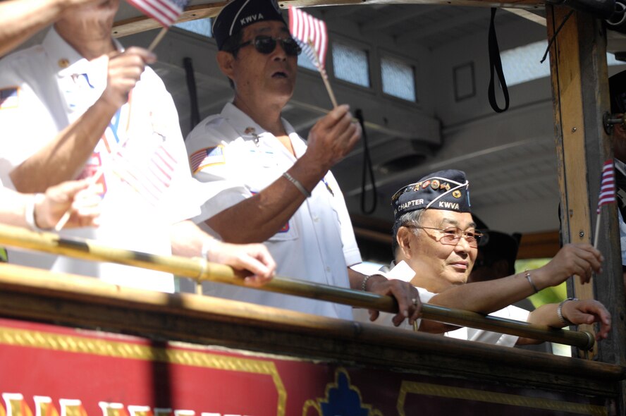 HONOLULU - Veterans of the Korean War wave their flags while riding in a trolley car during Honolulu, Hawaii's Welcome Home Parade as one of the many events held on May 22 in Honolulu to show support for the military members past and present stationed or living in Hawaii. Active duty, guard and reserve personnel participated in the parade, which was followed up with entertainment at the Waikiki Shell with performances by four local Hawaii bands and a military joint jazz ensemble. The event was organized by the USO, the Chamber of Commerce Military Affairs Council and BAE Systems. (U.S.  Air Force photo/Tech Sgt. Cohen A. Young)