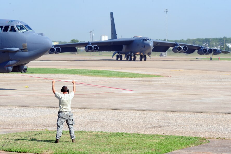 BARKSDALE AIR FORCE BASE, La. – Tech. Sgt. Marshall Spero, 2d Aircraft Maintenance Squadron crew chief, gives the pilot of a B-52H Stratofortress the signal to ‘stand-by’ as another B-52 taxis to the runway during a Nuclear Operational Readiness Exercise May 25. This is Barksdale’s second NORE of three before a Nuclear Operational Readiness Inspection slated for late June. (U.S. Air Force photo by Senior Airman Joanna M. Kresge)