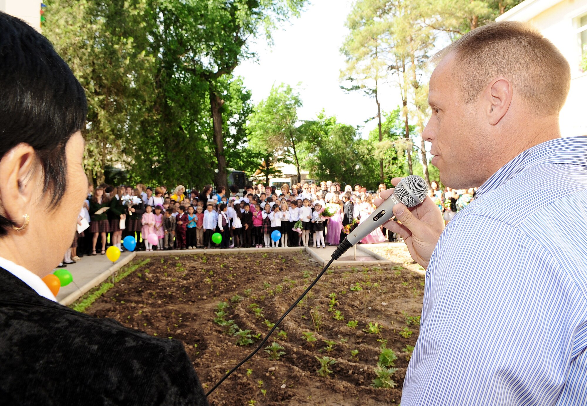 Col. Blaine Holt gives a brief speech during a graduation ceremony May 25, 2010, for children at the Birdik Village School, Kyrgyzstan. During his speech, Colonel Holt presented the school with a bus donated by the Transit Center at Manas, Kyrgyzstan. Colonel Holt is the director of the Transit Center. (U.S. Air Force photo/Senior Airman Nichelle Anderson)