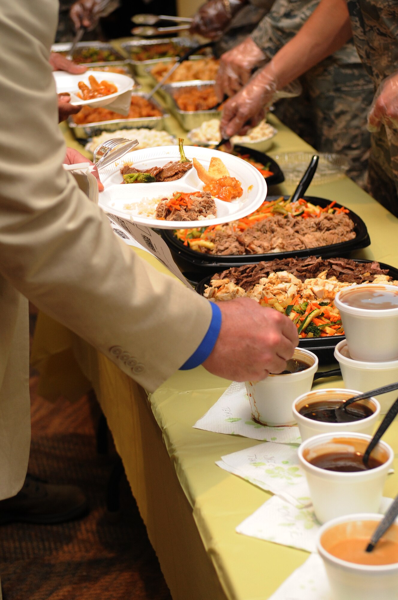 BUCKLEY AIR FORCE BASE, Colo. -- Members of Team Buckley sample cultural foods at the Asian Pacific Heritage food tasting May 26. (U.S. Air Force Photo by Airman 1st Class Manisha Vasquez)