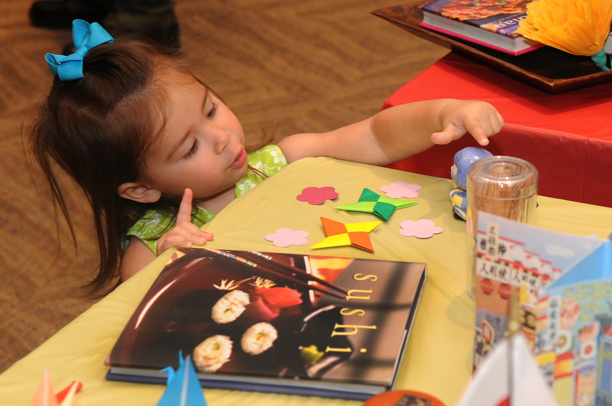 BUCKLEY AIR FORCE BASE, Colo.-- Two-year-old Samantha Holmes explores the different cultural displays at the Asian Pacific Heritage food tasting May 26. In addition to the food tasting, the event included cultural displays and live entertainment. (U.S. Air Force Photo by Airman 1st Class Manisha Vasquez)