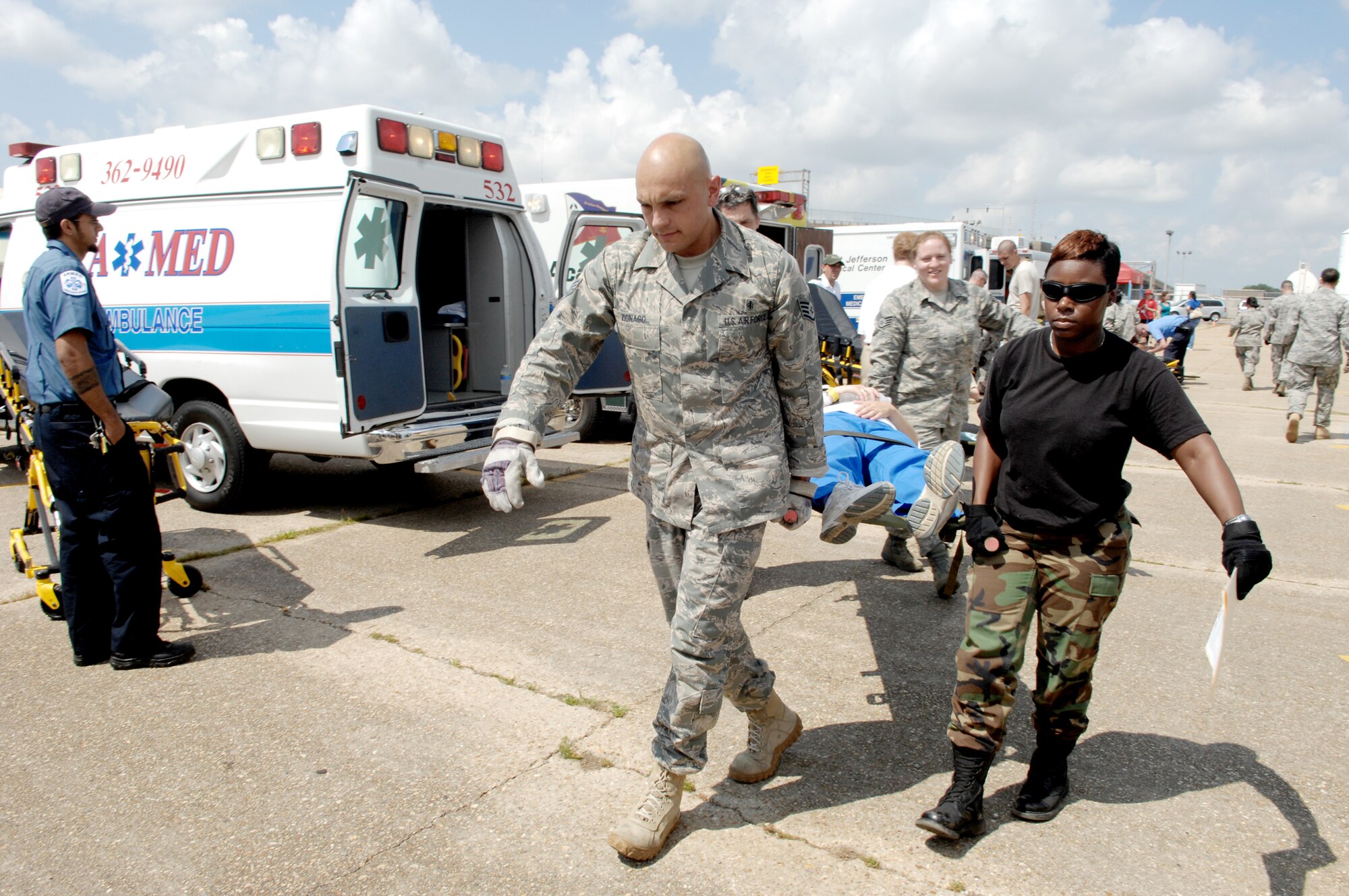 Members of the disaster aeromedical staging facility carry a simulated patient into the facility during an evacuation exercise May 20, 2010, at the New Orleans Lakefront Airport, La. The exercise was controlled by officials from the Louisiana Department of Health and Hospitals with the help of multiple military counterparts including Air Mobility Command and U.S. Transportation Command members from Scott Air Force Base, Ill. (U.S. Air Force photo/Senior Airman Samantha S. Crane)