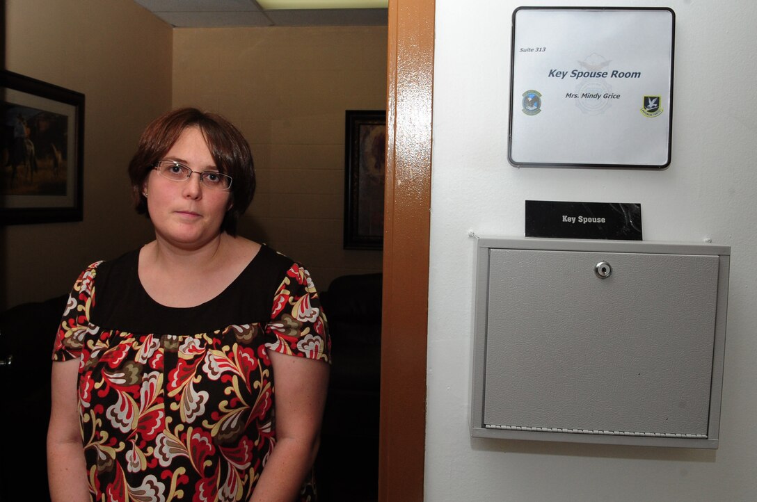 ELLSWORTH AIR FORCE BASE, S.D. - Mindy Grice, 28th Security Forces key spouse and wife of Master Sgt. Michael Grice, 28 SFS team leader, stands in front of the key spouse room located in the security forces building, May 24. The 28 SFS is the first organization on base to offer their key spouses a workspace inside their headquarters building. (U.S. Air Force photo/Airman 1st Class Corey Hook)