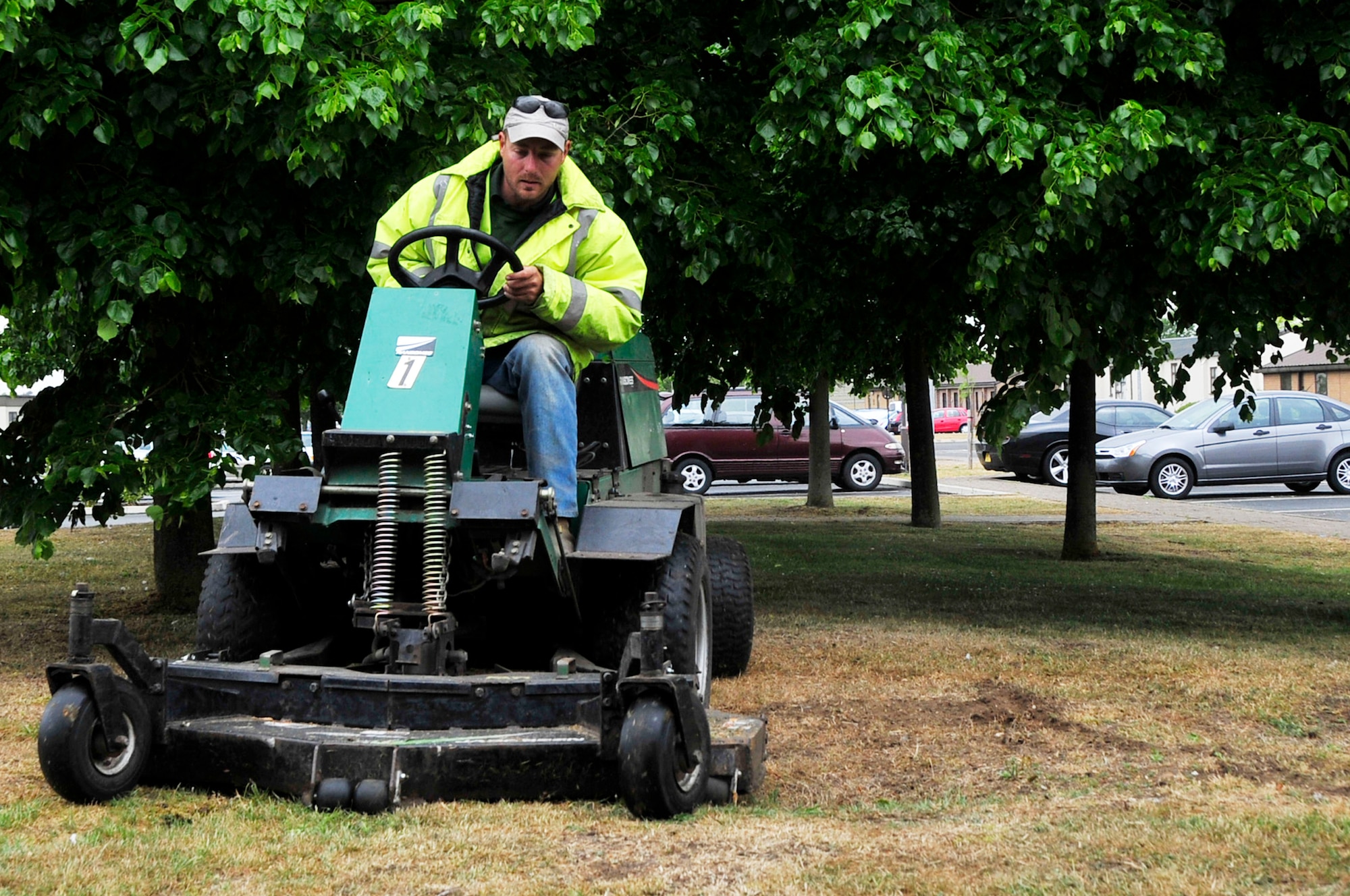 Paul Bone, a contractor hired to maintain the grouds around RAF Lakenheath England, mows the grass here May 27, 2009. While mowing the grass may seem easy, many areas of the base contain rare and protected plant life, such as the wild grape hyacinth and perennial knawel. Protecting these plants are taken extremly seriously, to the point where some grasslands aren't mowed September through February allowing them to grow freely. Also, there are special mowing techniques used in other areas, which mimics rabbit grazing. (U.S. Air Force photo/Airman 1st Class Lausanne Morgan)