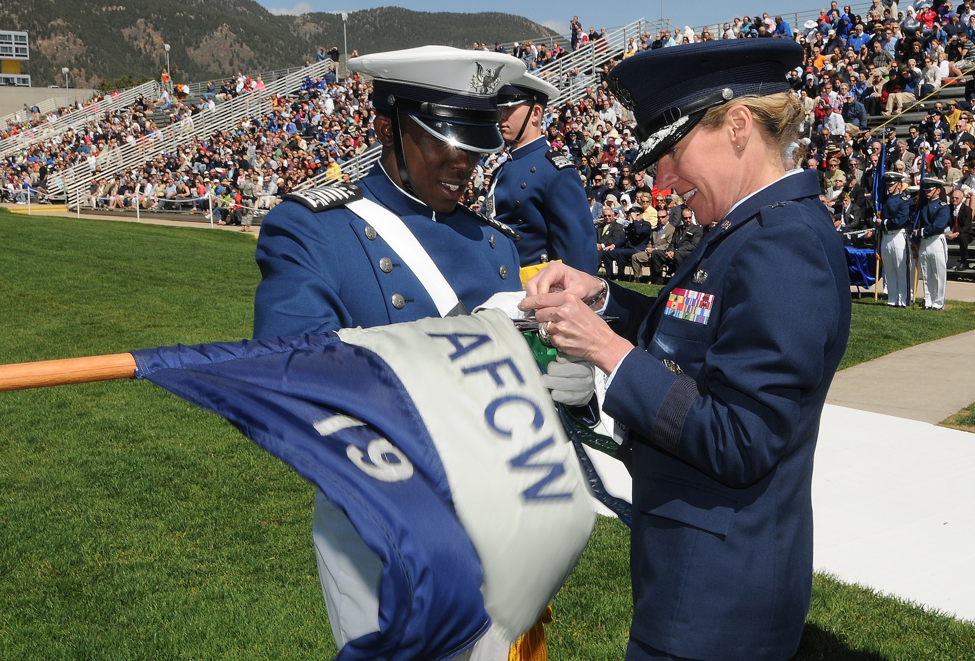 Cadet 1st Class Nathan Dial and Brig. Gen. Dana Born affix a 2010 Outstanding Squadron banner to Cadet Squadron 19's guidon during the Individual Awards Parade at the U.S. Air Force Academy's Stillman Parade Field May 24, 2010. Cadet Dial was the Fall 2009 Cadet Wing commander. General Born is the dean of the faculty. (U.S. Air Force photo/Rachel Boettcher)