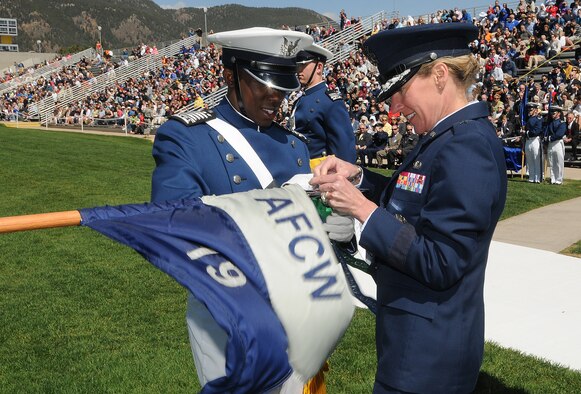 Cadet 1st Class Nathan Dial and Brig. Gen. Dana Born affix a 2010 Outstanding Squadron banner to Cadet Squadron 19's guidon during the Individual Awards Parade at the U.S. Air Force Academy's Stillman Parade Field May 24, 2010. Cadet Dial was the Fall 2009 Cadet Wing commander. General Born is the dean of the faculty. (U.S. Air Force photo/Rachel Boettcher)