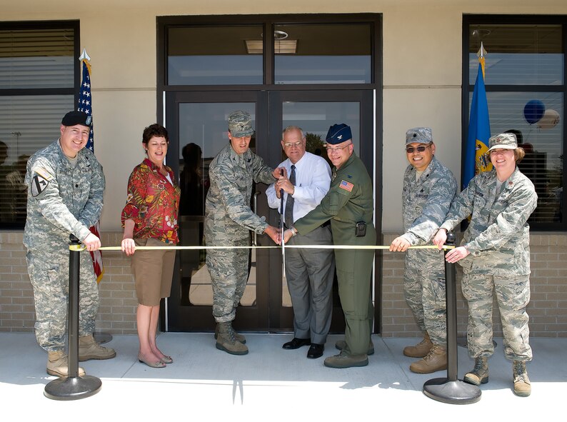 (Left)Lt. Col. Anthony Streletz, Army Corp of Engineers deputy commander, Lori James, representing Senator Tom Carper, Col. Dwight Sones, 436th Airlift Wing vice commander, The Honorable Carleton Carey Sr., Mayor of Dover, Col. Randal Bright, 512th Airlift Wing commander, Lt. Col. Harold Bugado, 436th Mission Support Group deputy commander, and Maj. Teresa Darrow, 436th Force Support Squadron commander, help to cut the ribbon of the new Outdoor Recreation Center May 21. The Outdoor Recreation Center will be the new focal point for all of Dover Air Force Base outdoor rental needs. (U.S. Air Force photo/Jason Minto)