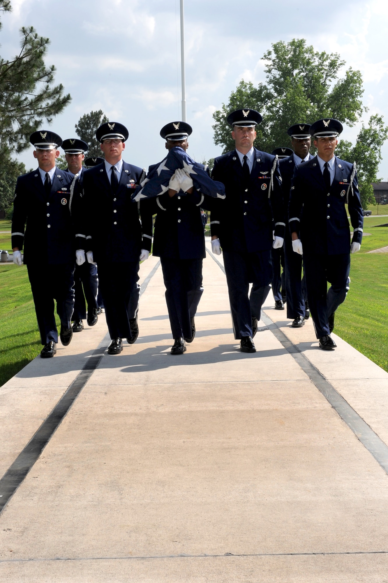 Members of the base’s Honor Guard carry the American flag near the end of May 26 Memorial Day retreat ceremony. (U.S. Air Force photo by Senior Airman Ethan Morgan)