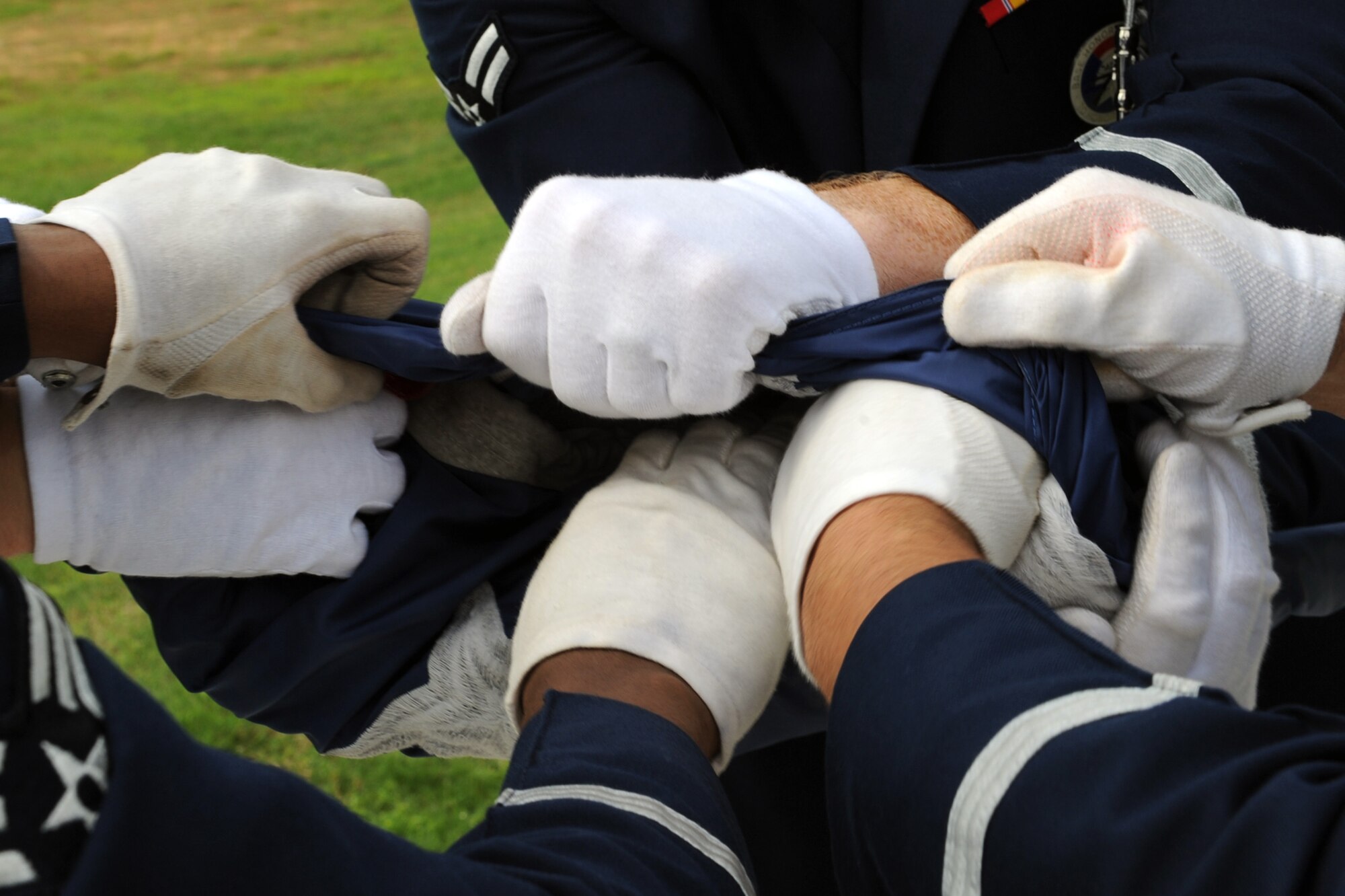 Little Rock Air Force Base Honor Guard Airmen tuck the flag into itself before securing it during May 26 Memorial Day retreat ceremony. (U.S. Air Force photo by Senior Airman Ethan Morgan)