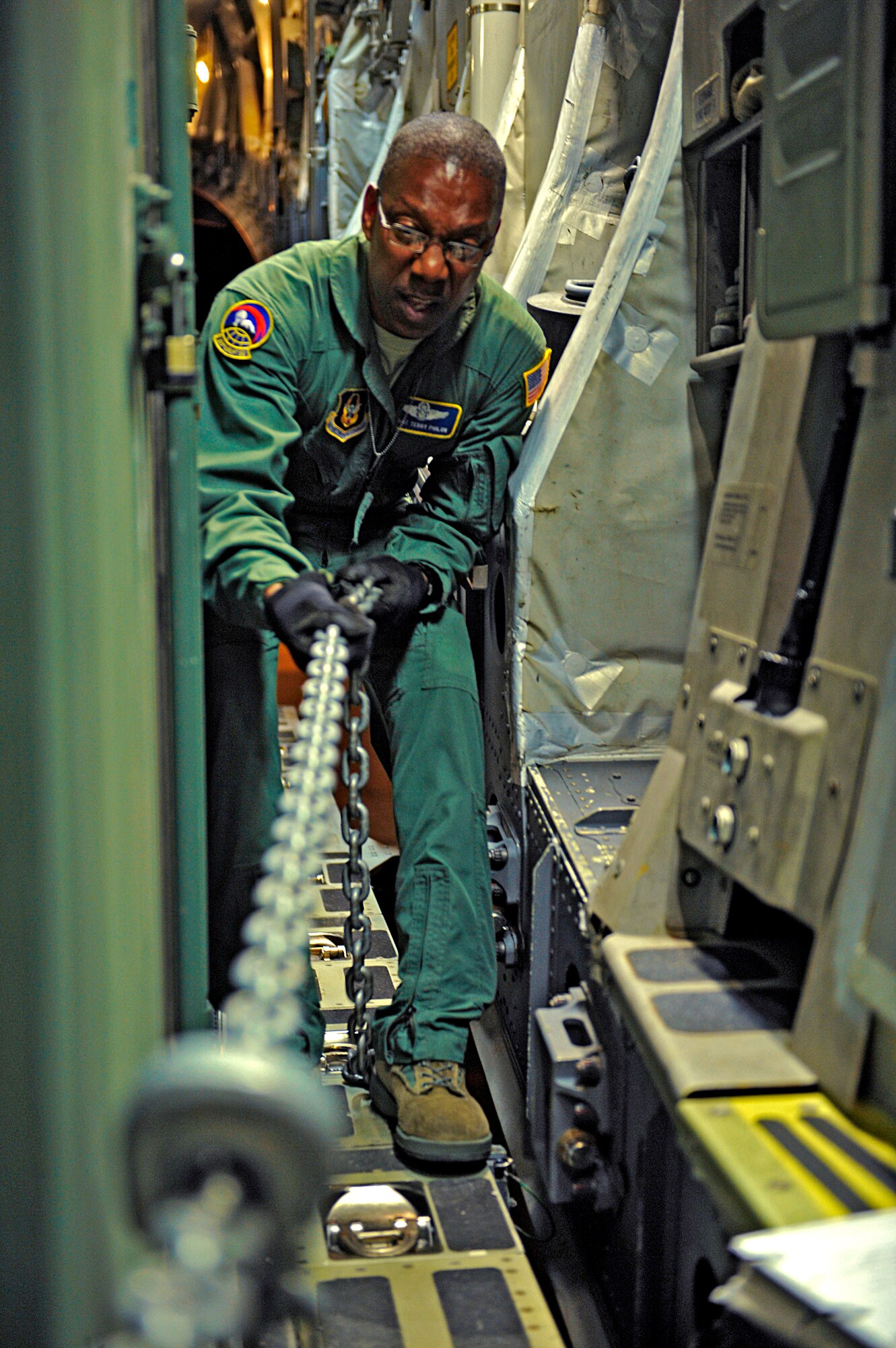 HOLLOMAN AIR FORCE BASE, N.M. -- Senior Master Sgt. Terrance Philon, 313th Airlift Squadron, secures the position of cargo loaded onto a C-17 Globemaster from McChord Air Force Base, Wash., in support of the recent deployment to Kadena Air Base, Japan, May 22, 2010. Team Holloman members deployed in support of U.S. Pacific Command's Theater Security Package. (U.S. Air Force photo by Staff Sgt. Anthony Nelson Jr. / Released) 
