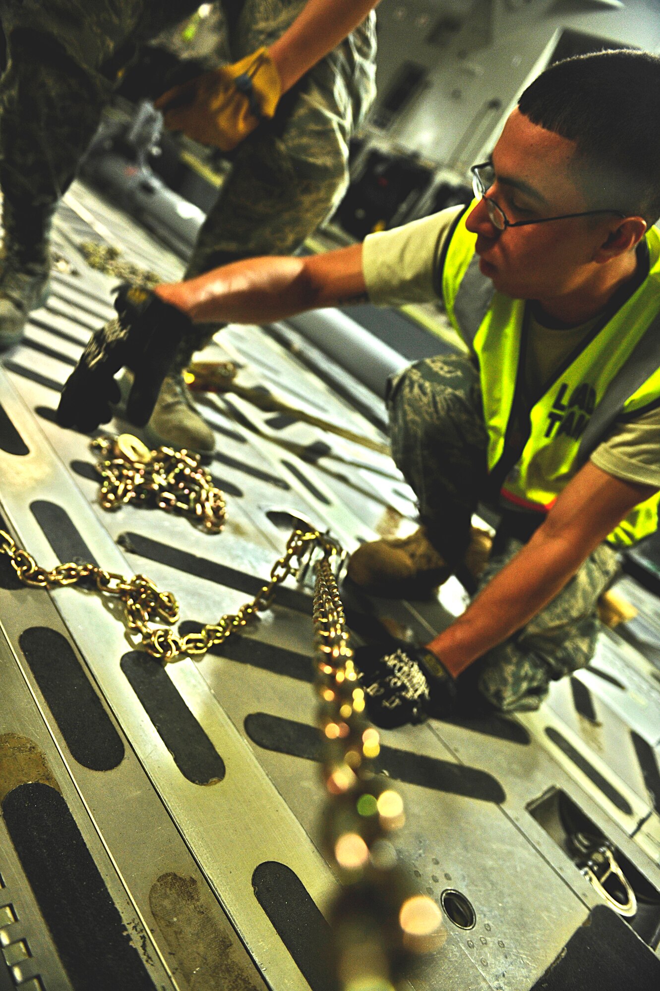 HOLLOMAN AIR FORCE BASE, N.M. -- A load team member secures cargo onto a floor board of a C-17 Globemaster from McChord Air Force Base, Wash., May 22, 2010, in support of a deployment to Kadena Air Base, Japan. Team Holloman members deployed to Kadena AB in support of U.S. Pacific Command's Theater Security Package. As part of continuing force posture adjustments to address worldwide requirements, the United States Department of Defense continues to deploy additional forces throughout the Western Pacific.  (U.S. Air Force photo by Staff Sgt. Anthony Nelson Jr./ Released)
