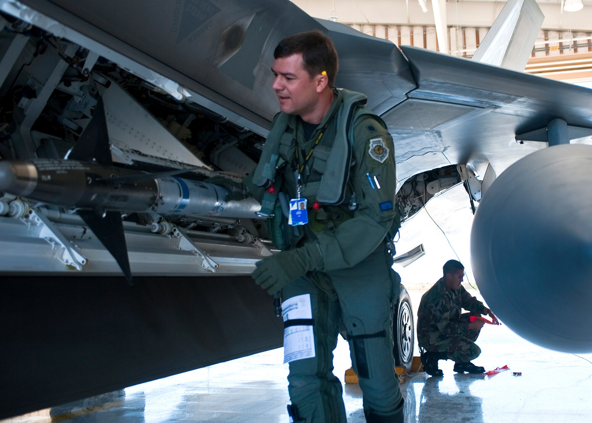 HOLLOMAN AIR FORCE BASE, N.M. -- Lt. Col. Robert Teschner, 7th Fighter Squadron commander, inspects the weapons bay on an F-22 Raptor as a part of his pre-flight walk before takeoff May 24, 2010. F-22's from Holloman deployed to Kadena Air Base, Japan, for approximately four months as part of a U.S. Pacific Command Theater Security Package. (U.S. Air Force photo by Senior Airman DeAndre Curtiss / Released)