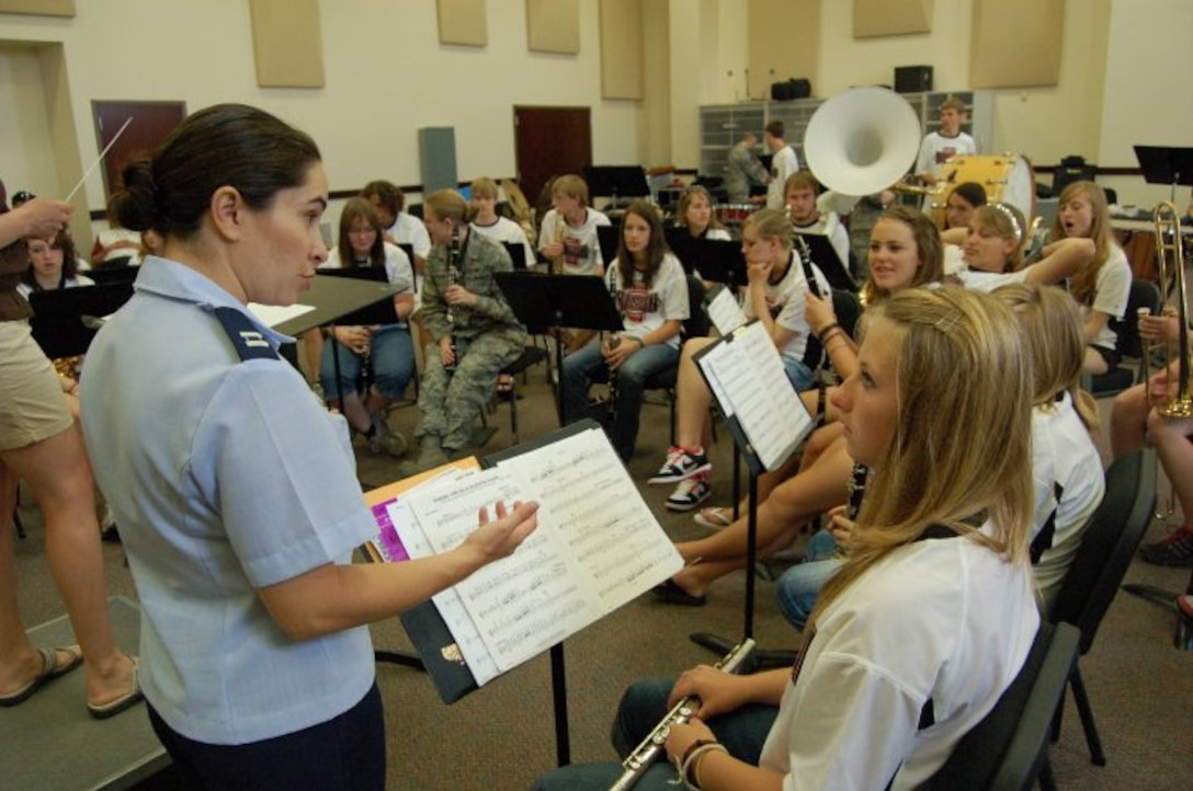 Captain Cristina Moore Urrutia gives some musical pointers to a flute student from McCook High School.  The students were visiting San Antonio on a band trip from McCook, Nebraska.