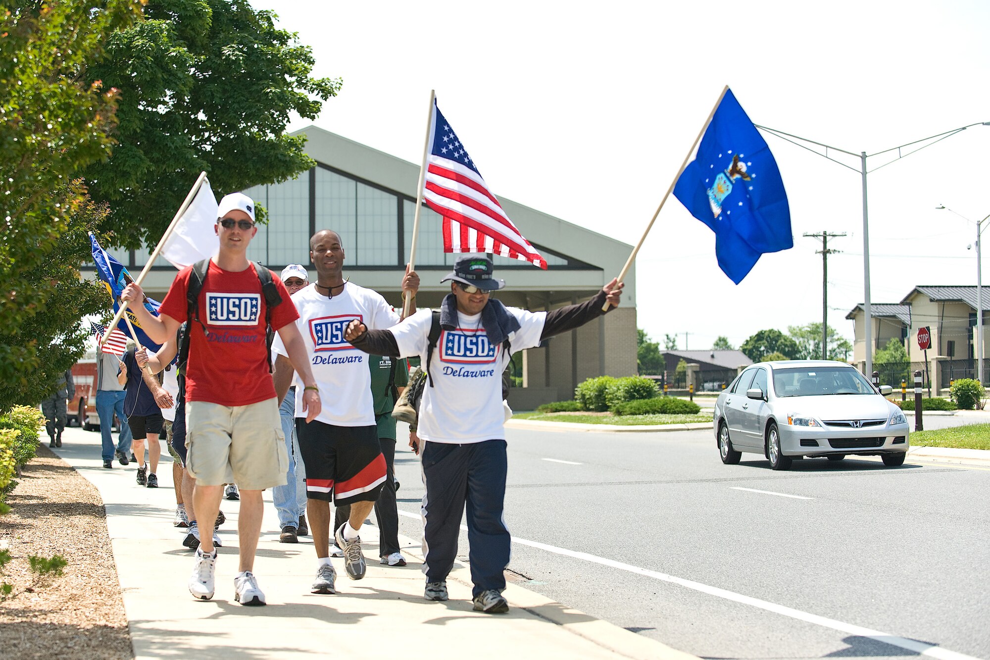 Particpants in the 2010 USO Base 2 Base march walk toward the 436th Airlift Wing Headquarters on Dover Air Force Base, Del., May 21, 2010. The March is a 47-mile journey that starts at Delaware Air National Guard Headquarters and ends at Dover AFB. (U.S. Air Force photo/Roland Balik)