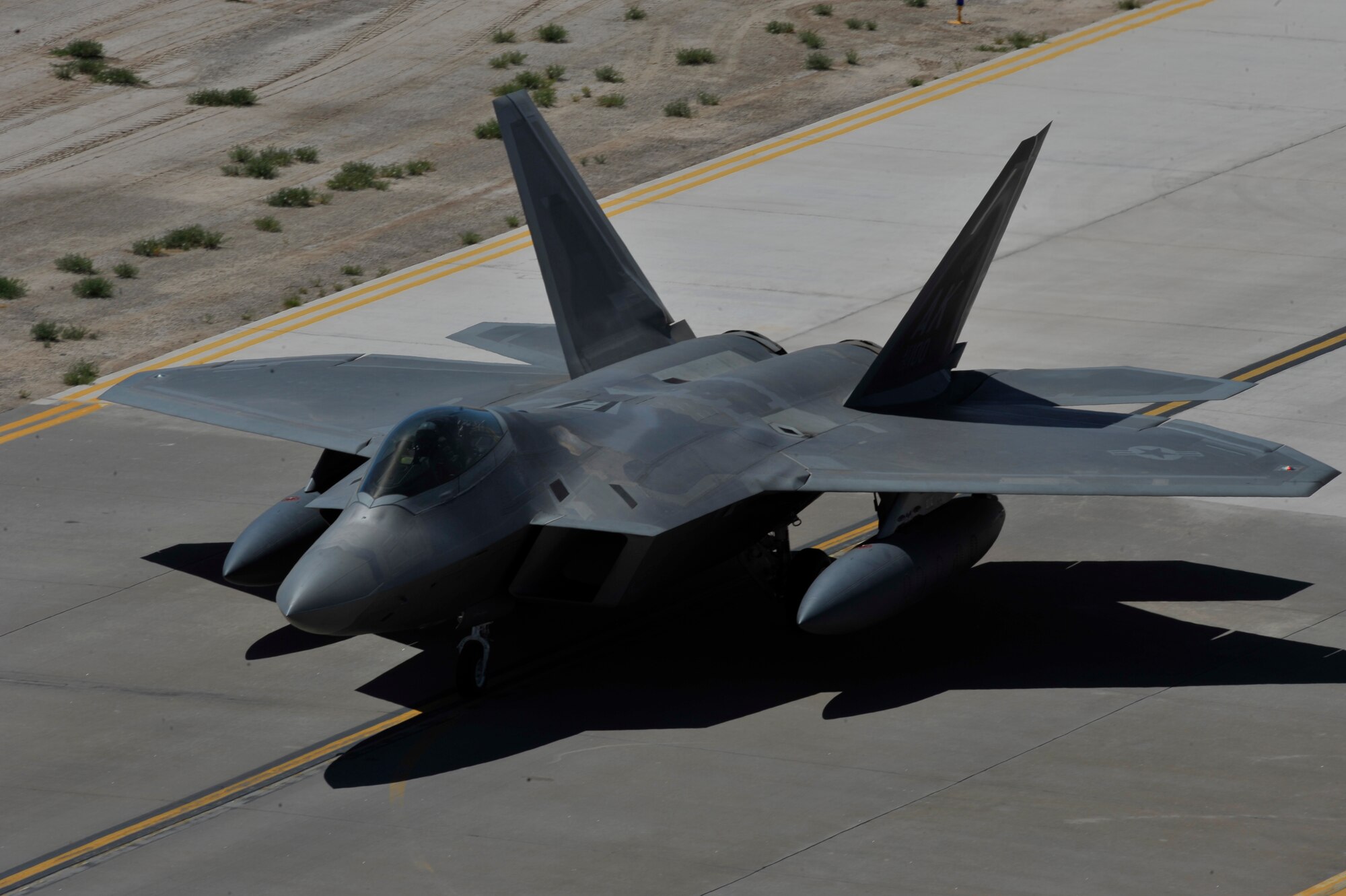 HOLLOMAN AIR FORCE BASE, N.M. -- An F-22 Raptor assigned to Holloman prepares to take off May 24, 2010, as part of a deployment to Kadena Air Base, Japan. As part of continuing force posture adjustments to address worldwide requirements, the United States continues to deploy additional forces throughout the Western Pacific as part of U.S. Pacific Command's Theater Security Package. This is the latest example of the flexibility U.S. forces have to meet their ongoing commitments and security obligations throughout the Pacific region. (U.S. Air Force photo by Airman 1st Class Joshua Turner / Released)
