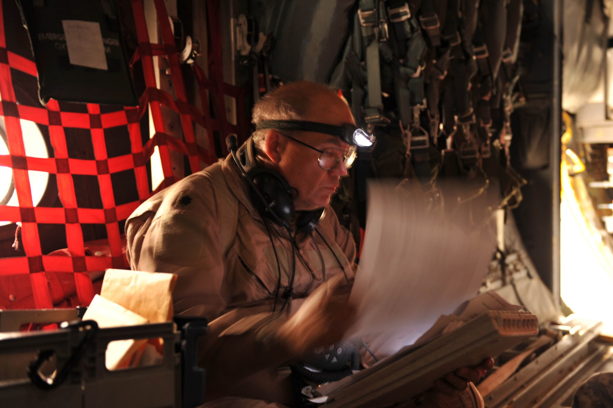 U.S. Air Force flight nurse, Lt. Col. Jeffery Starr, checks a patient's paperwork during an aeromedical evacuation mission in Iraq, May 13, 2010.  Colonel Starr is deployed to the 332nd Expeditionary Aeromedical Evacuation Flight, Joint Base Balad, Iraq.  (U.S. Air Force photo/Staff Sgt. Quinton Russ/released)