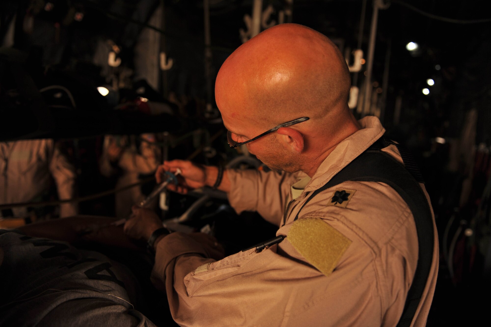 U.S. Air Force flight doctor, Lt. Col. Scott Vandenhoef, administers some medication during an aeromedical evacuation mission, May 13, 2010.  Doctor Vandenhoef is deployed to the 451st Expeditionary Aeromedical Evacuation Squadron, Camp Bastion, Afghanistan.  (U.S. Air Force photo/Staff Sgt. Quinton Russ/released)