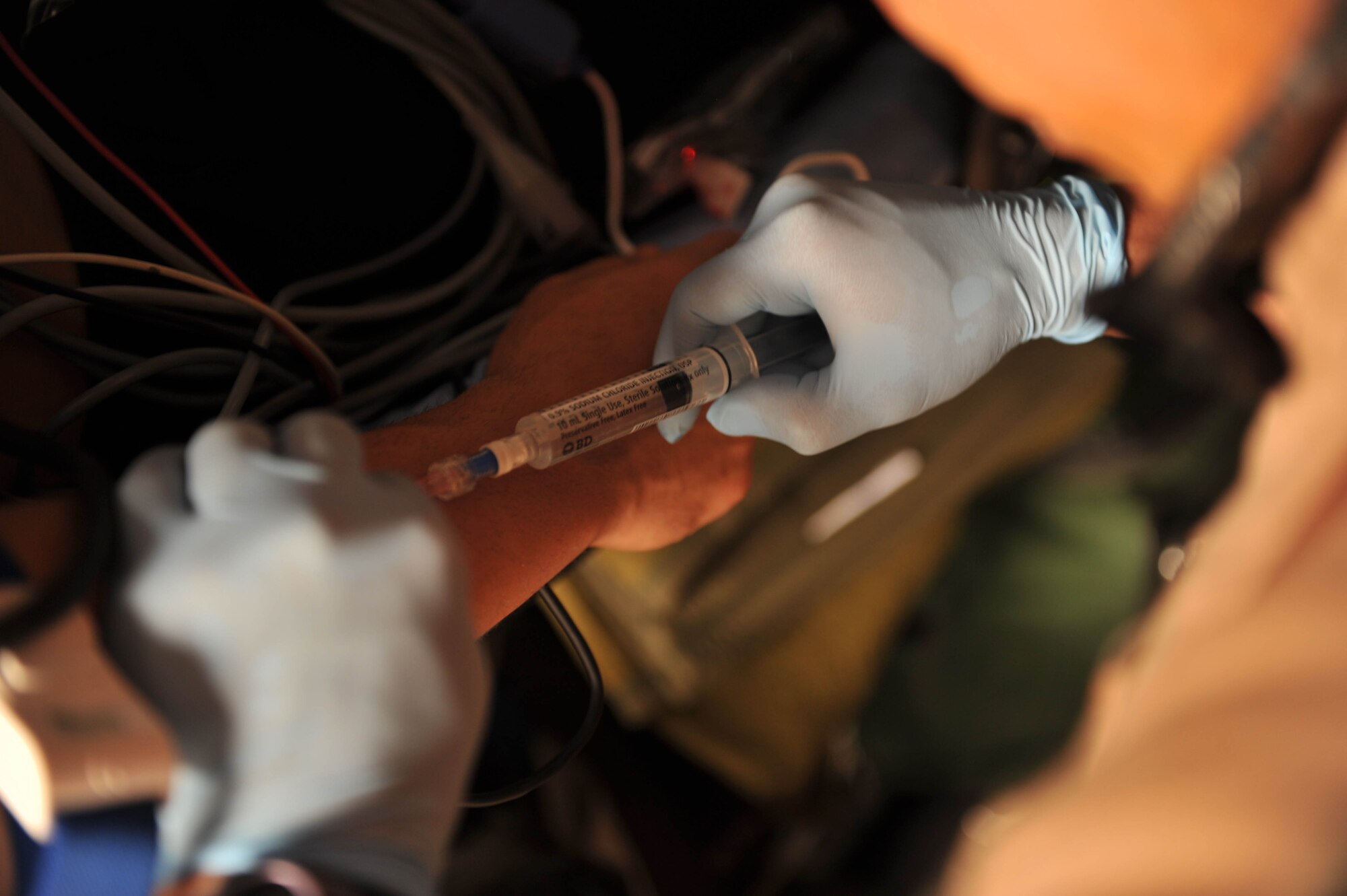 U.S. Air Force flight nurse, 1st Lt. James Carver, administers medication during an aeromedical evacuation mission, May 13, 2010.  Lieutenant Carver is deployed to the 451st Expeditionary Aeromedical Evacuation Squadron, Camp Bastion, Afghanistan.  (U.S. Air Force photo/Staff Sgt. Quinton Russ/released)