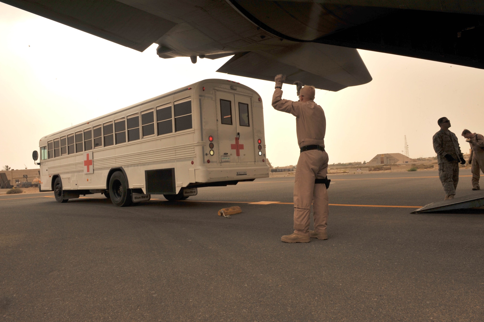 U.S. Air Force loadmaster, Airman 1st Class Joshua Kindell, guides a bus to the back of a C-130 Hercules at Joint Base Balad, Iraq, May 13, 2010.  Airman Kindell is deployed to the 777th Expeditionary Airlift Squadron, Joint Base Balad, Iraq.  (U.S. Air Force photo/Staff Sgt. Quinton Russ/released)
