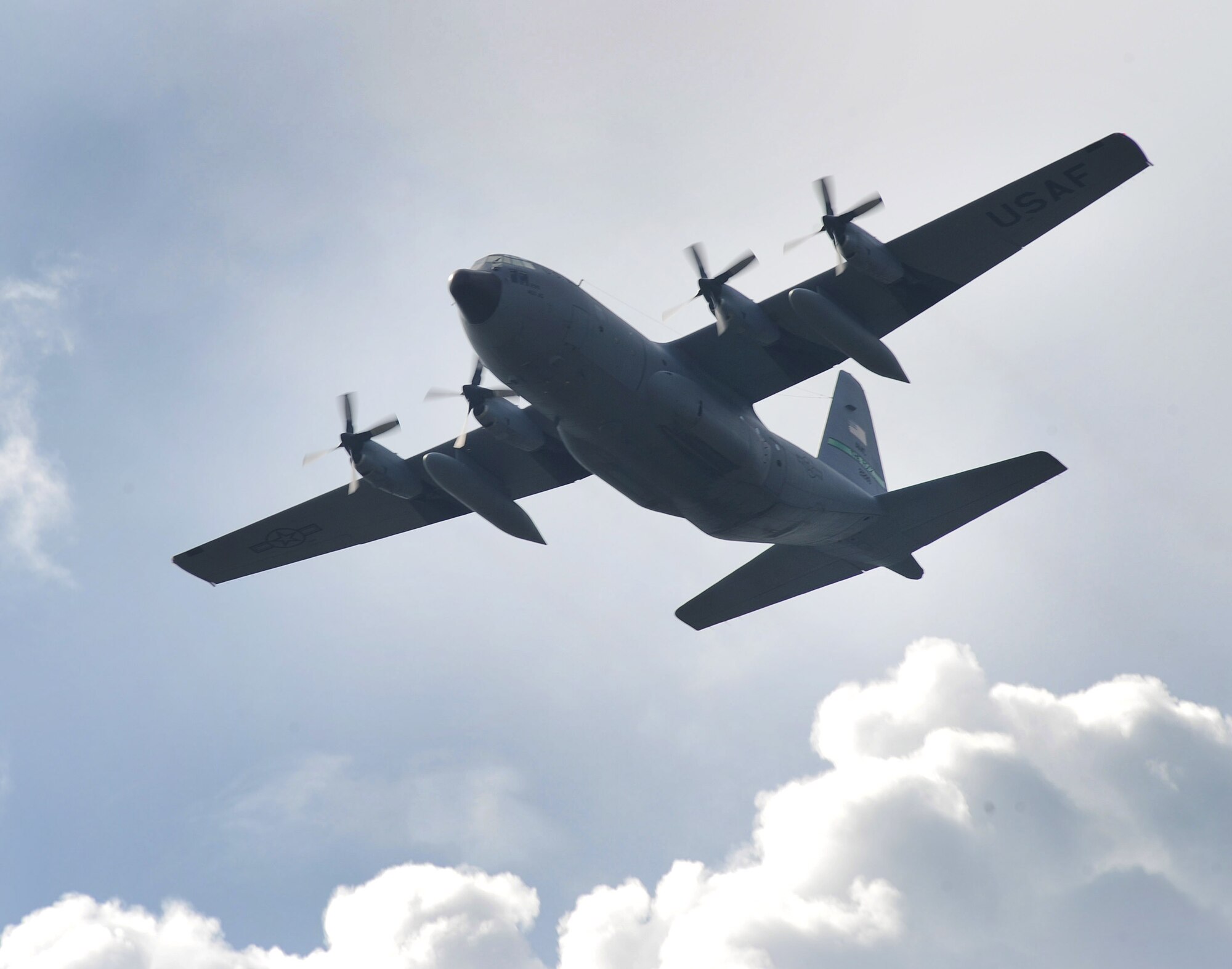 A 61st Airlift Squadron C-130E performs a fly-by during the Memorial Day retreat ceremony May 26. (U.S. Air Force photo by Staff Sgt. Chad Chisholm)